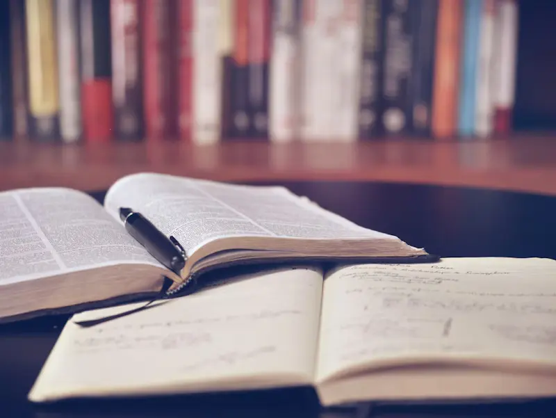 Close-up of a typed academic paper displaying complex mathematical equations, structured footnoting, and bibliography tracking.